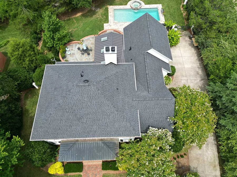 Aerial view of a home with a new roof and gutters
